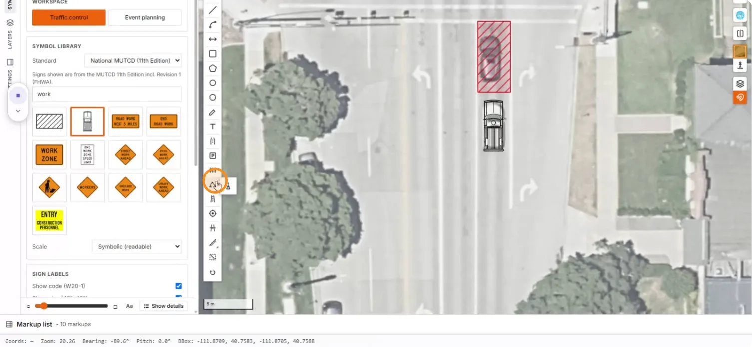 A red hatched work area and work truck placed in the closed lane