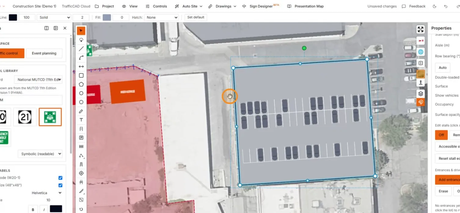 The entrance with paired in/out arrows, stalls re-flowed around the drive lane